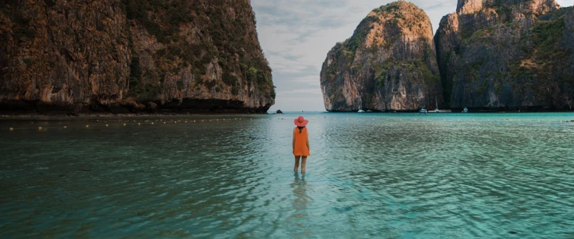 Lady in orange dress standing on island in Phuket, Thailand
